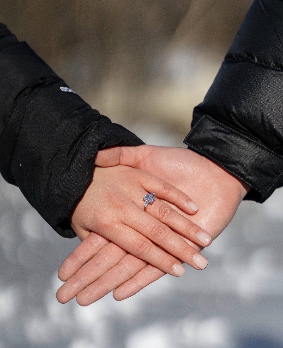 Emerald cut engagement ring on hand