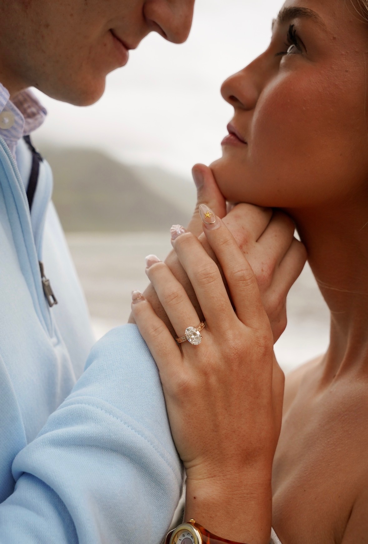Oval diamond engagement ring on hand, engagement session